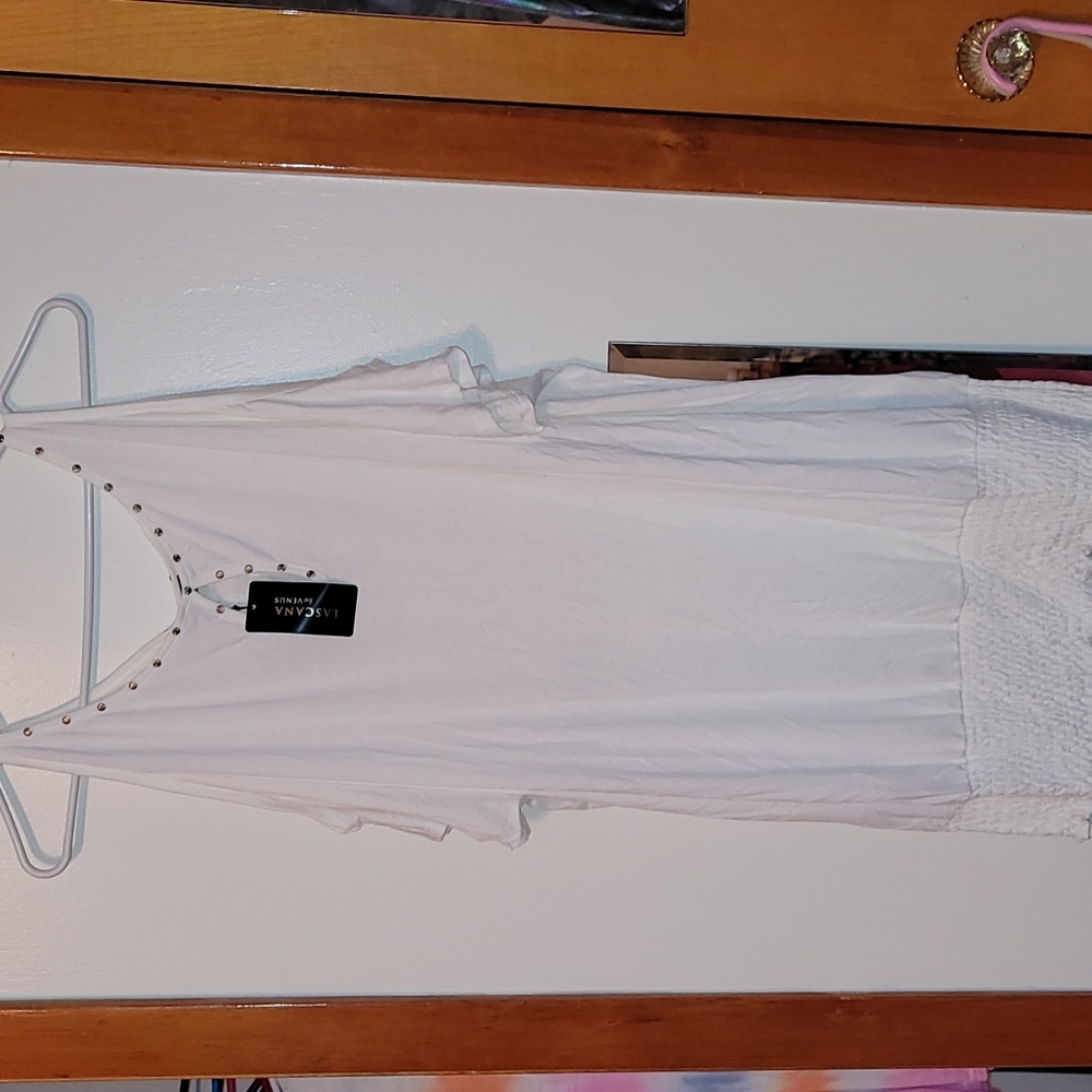 White size L short sleeved shirt with the shoulders cut out.